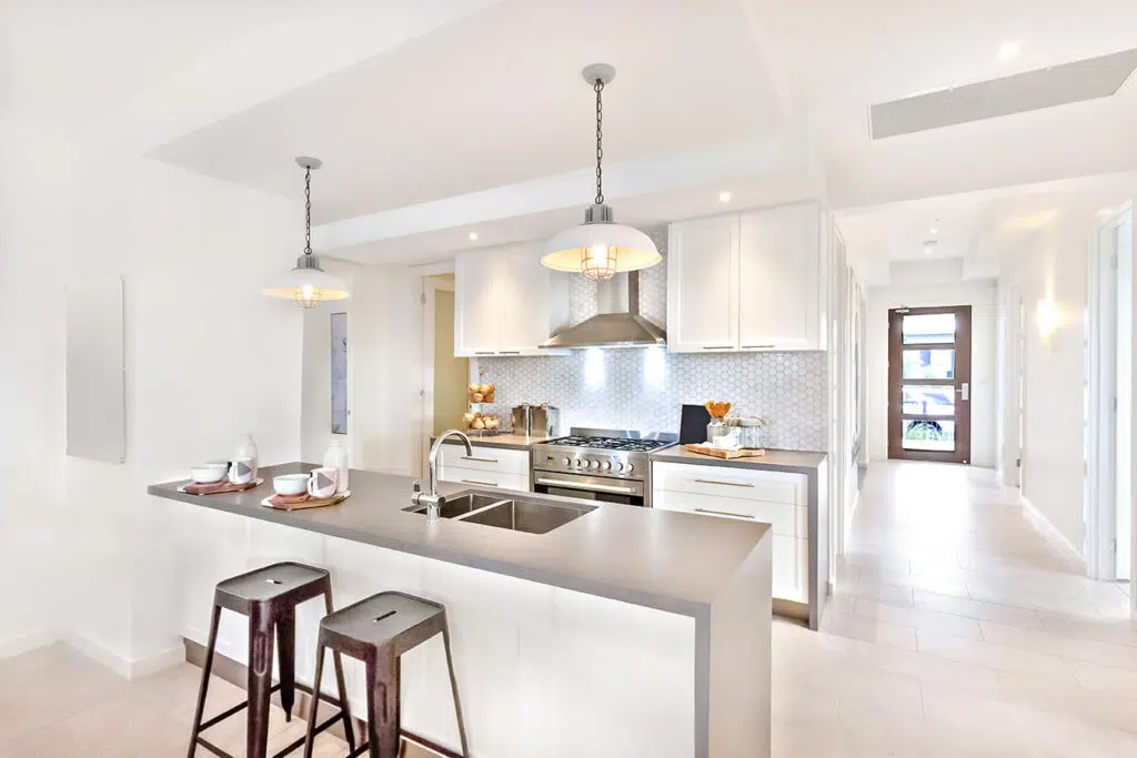 Modern kitchen with sleek countertops and stylish lighting.