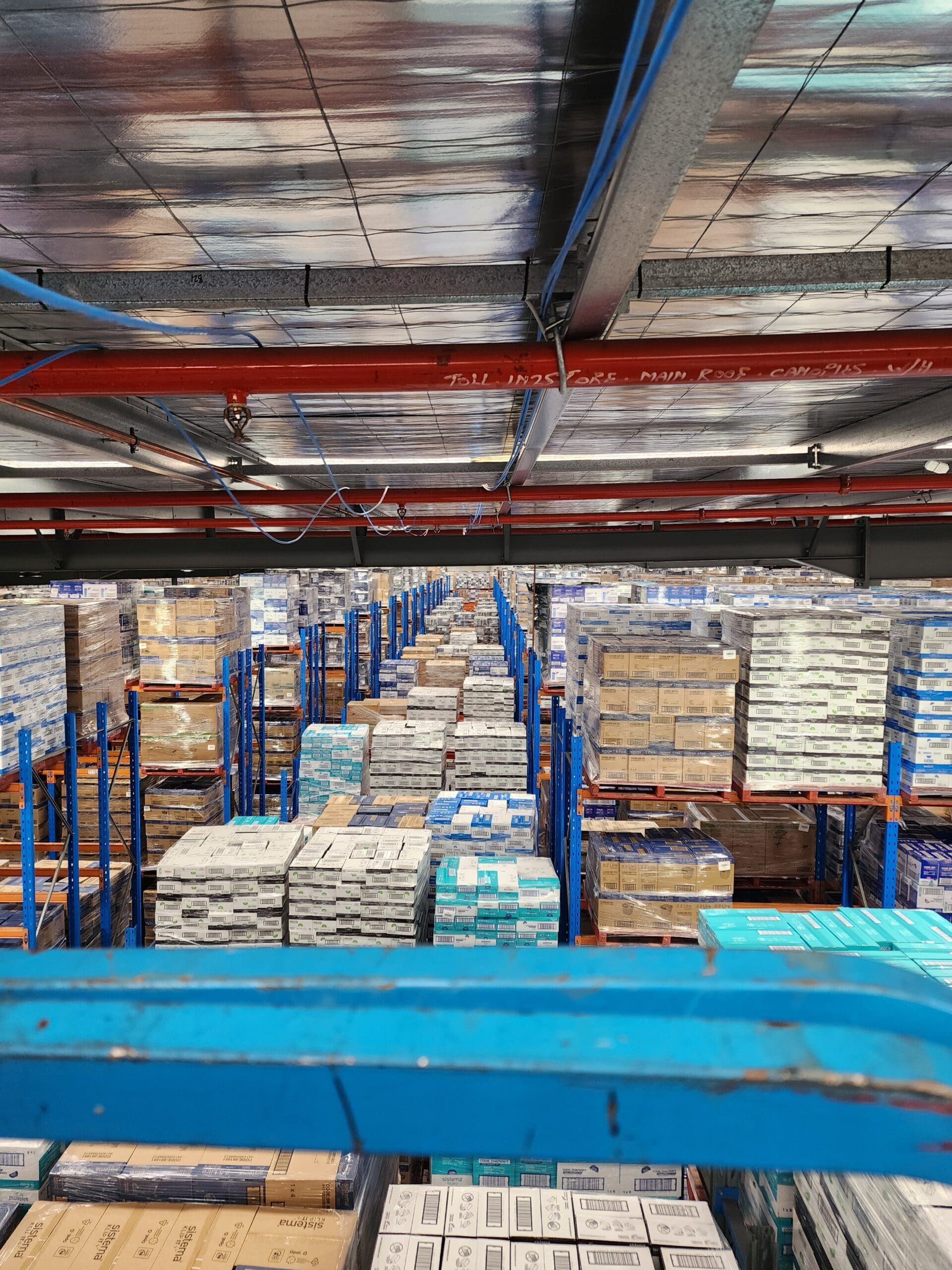 High view of a warehouse filled with stacked boxes on shelves.